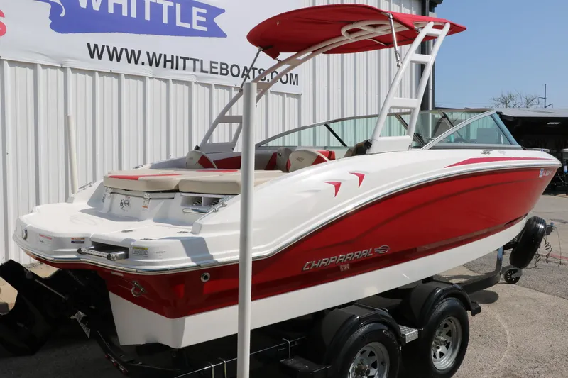 Slide: The Image of 2014 Chaparral 21 H2O Ski & Fish boat, red and white, on trailer at dealership. - 3