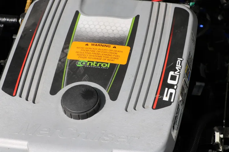 Slide: The Image of Engine cover of a 2014 Chaparral 21 H2O Ski & Fish boat, featuring 5.0 MPI branding. - 35