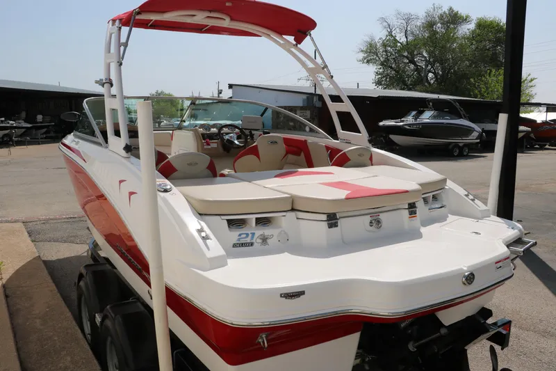 Slide: The Image of 2014 Chaparral 21 H2O Ski & Fish boat with red and white design, parked on a trailer. - 5
