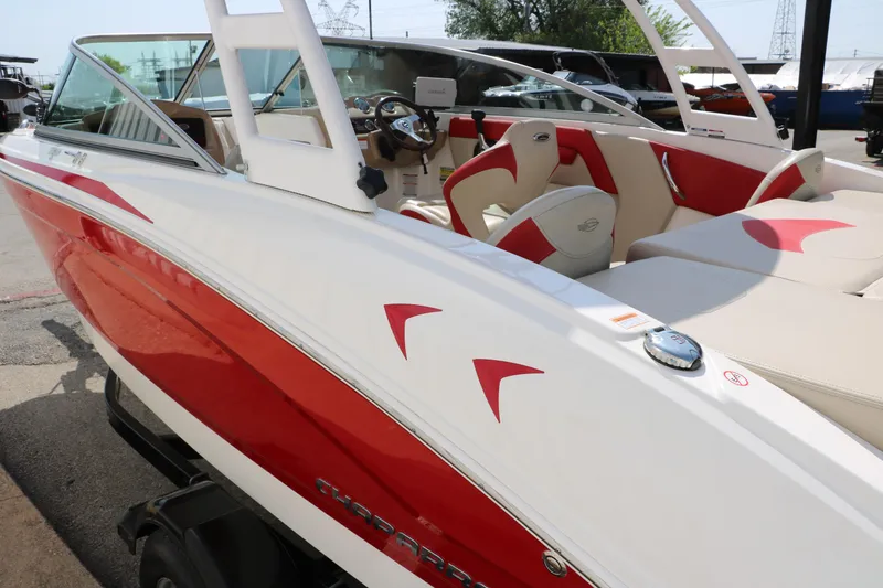 Slide: The Image of 2014 Chaparral 21 H2O Ski & Fish boat with red and white design, docked outdoors. - 6