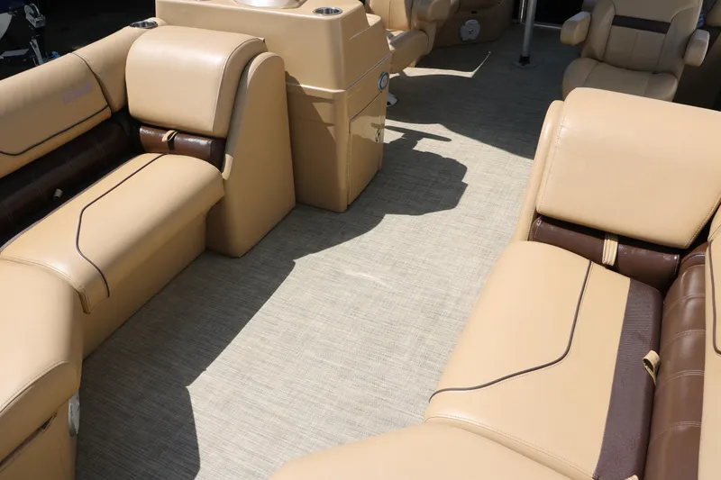 Slide: The Image of 2019 Lowe SS210 boat interior with beige seating and carpet flooring. - 18
