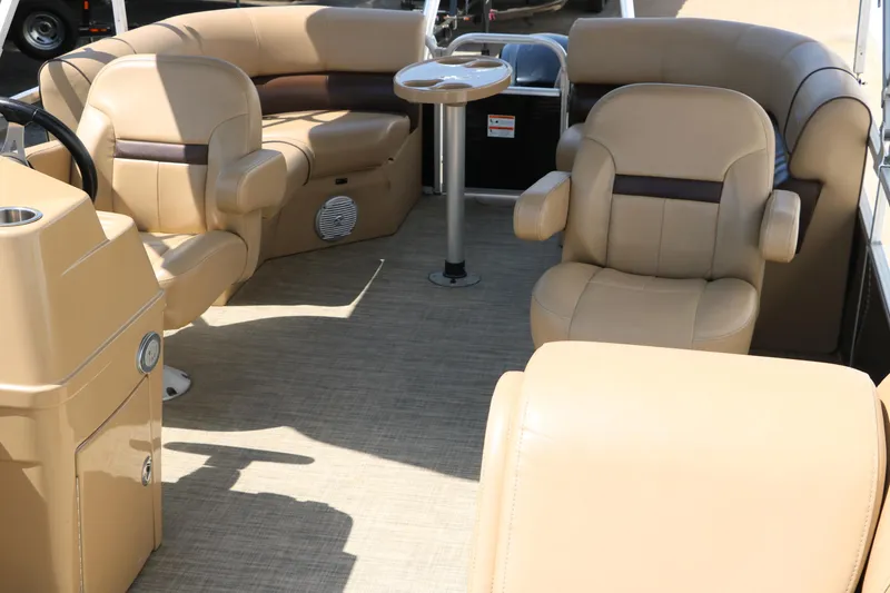 Slide: The Image of 2019 Lowe SS210 boat interior with beige seating and a small table. - 19
