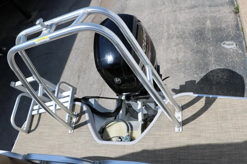 Slide: The Image of 2019 Lowe SS210 boat with outboard motor and metal railing on deck. - 25