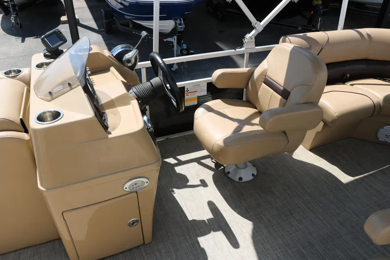 Slide: The Image of 2019 Lowe SS210 boat interior with tan seating and steering console. - 28