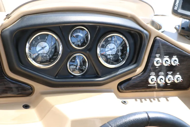 Slide: The Image of Dashboard of a 2019 Lowe SS210 boat with gauges and control switches. - 30