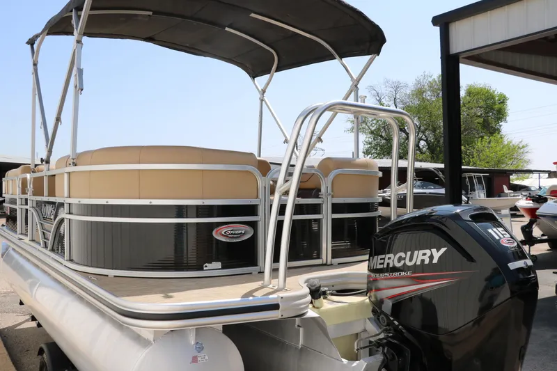Slide: The Image of 2019 Lowe SS210 pontoon boat with Mercury outboard motor, docked outdoors. - 5
