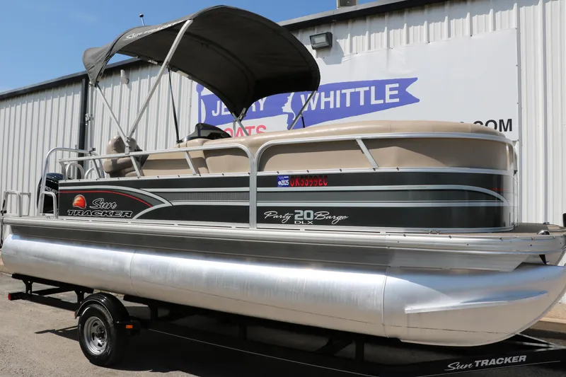 Slide: The Image of 2015 Sun Tracker Party Barge 20 DLX pontoon boat on trailer, parked outside. - 12