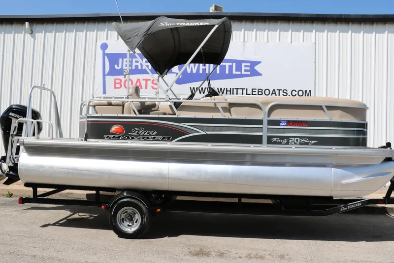 Slide: The Image of 2015 Sun Tracker Party Barge 20 DLX pontoon boat on trailer, parked outside dealership. - 13