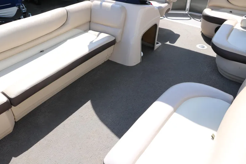 Slide: The Image of 2015 Sun Tracker Party Barge 20 DLX interior with beige seating and carpeted floor. - 17