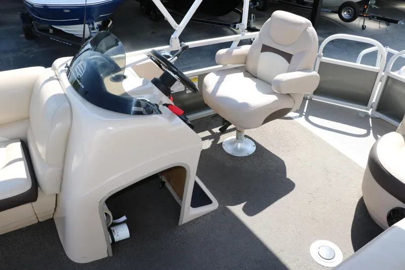 Slide: The Image of 2015 Sun Tracker Party Barge 20 DLX interior with captain's chair and console. - 28