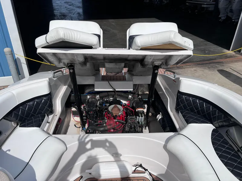 Slide: The Image of 2004 Four Winns 240 Horizon boat engine compartment with open seating and visible engine. - 12