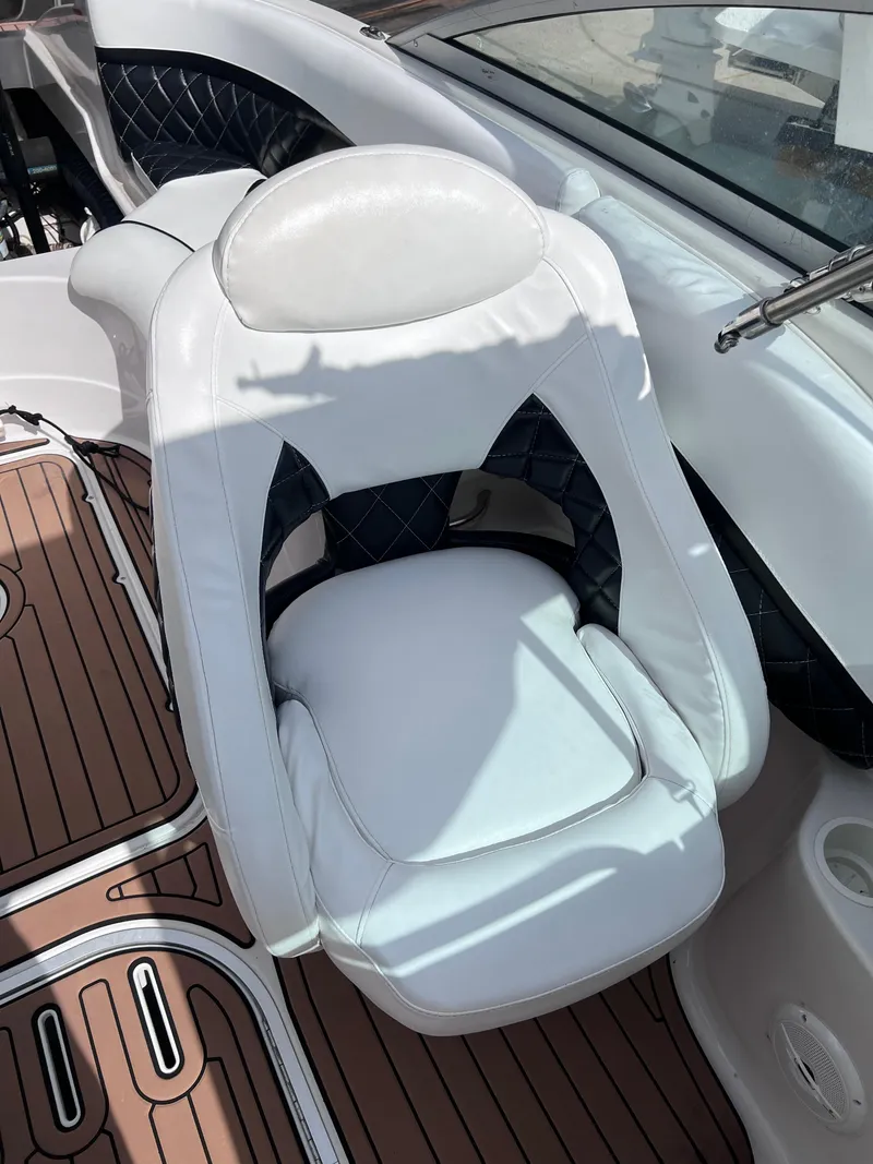 Slide: The Image of 2004 Four Winns 240 Horizon boat seat with white upholstery and wood-patterned flooring. - 17