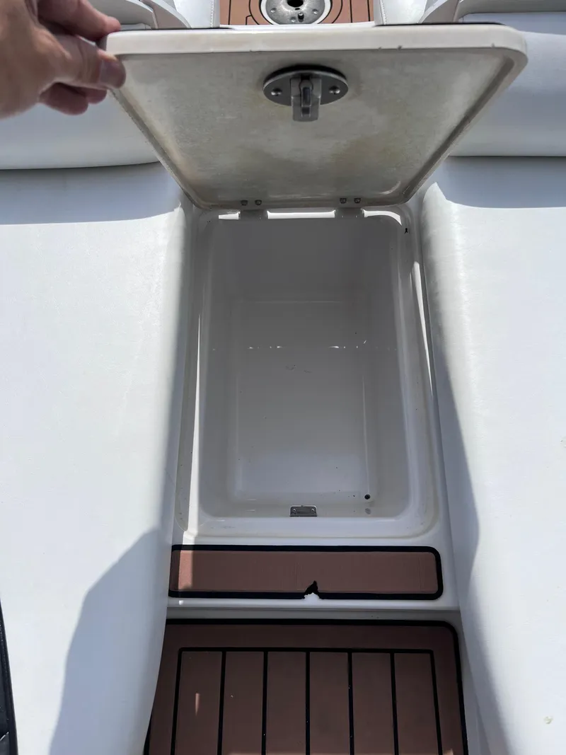 Slide: The Image of Open storage compartment on 2004 Four Winns 240 Horizon boat. - 18