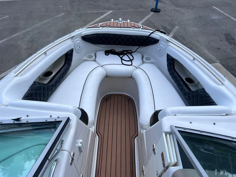 Slide: The Image of 2004 Four Winns 240 Horizon boat interior with white seating and wood-style flooring. - 19