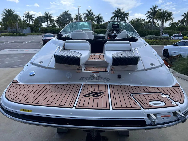 Slide: The Image of 2004 Four Winns 240 Horizon boat with teak deck, parked near palm trees. - 7