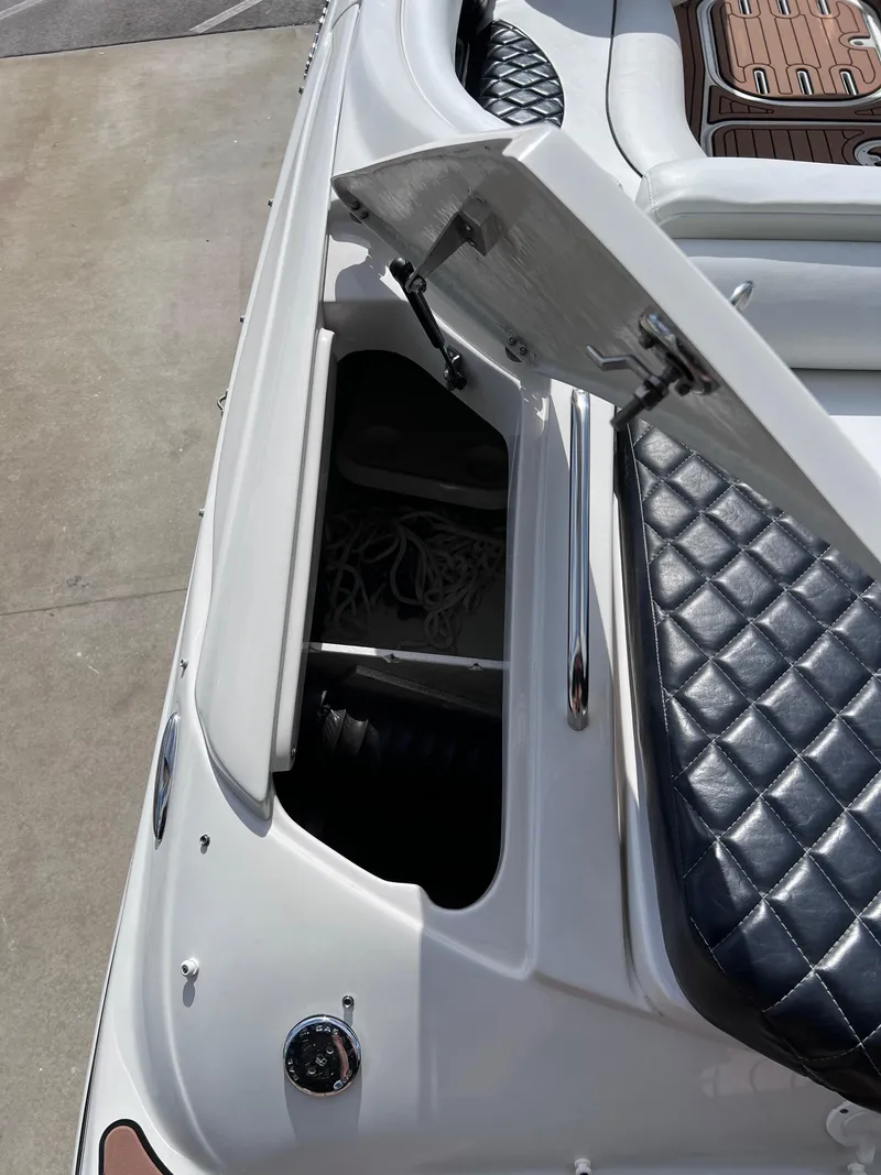 Slide: The Image of 2004 Four Winns 240 Horizon boat with open storage compartment and quilted seating. - 8