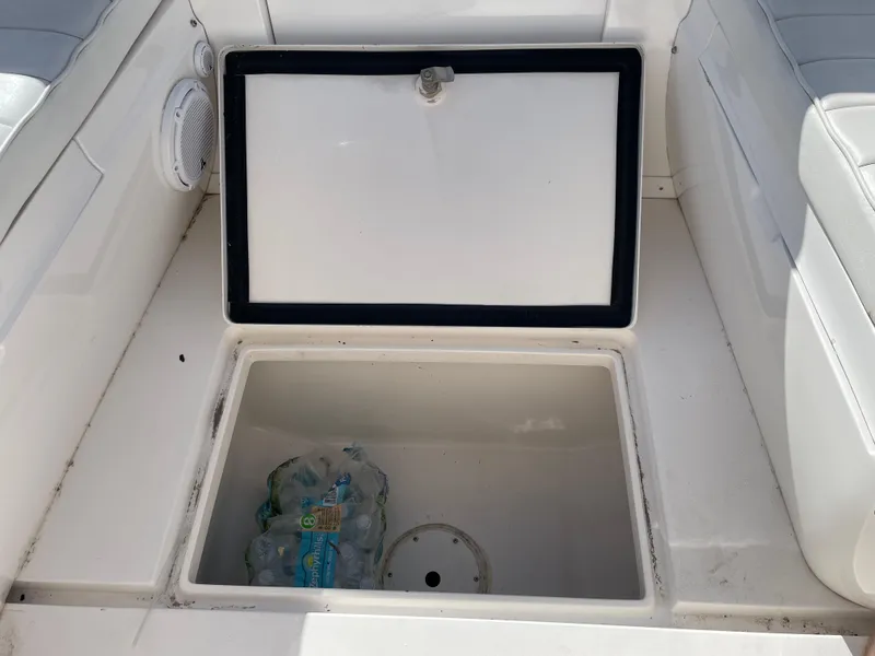 Slide: The Image of Storage compartment on 2008 Intrepid 323 Cuddy boat with water bottles inside. - 26