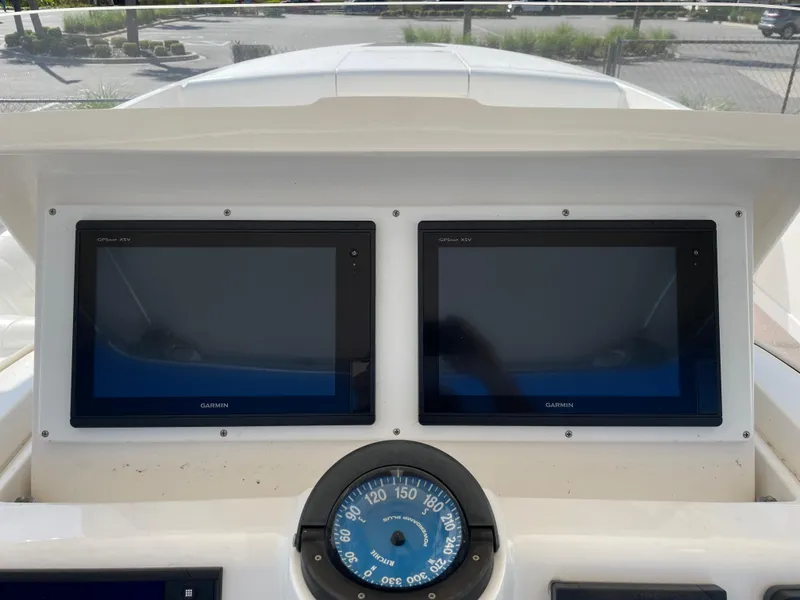 Slide: The Image of Dashboard of 2008 Intrepid 323 Cuddy with dual Garmin displays and compass. - 30