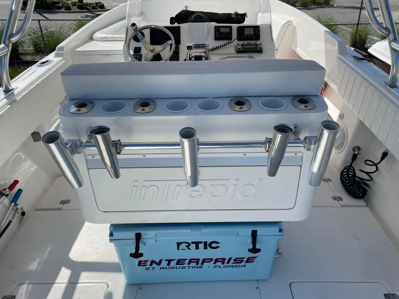 Slide: The Image of 2008 Intrepid 323 Cuddy boat interior with fishing rod holders and RTIC cooler. - 40