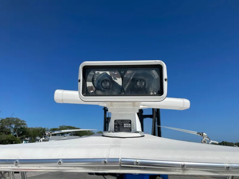 Slide: The Image of Spotlight on 2008 Intrepid 323 Cuddy boat under clear blue sky. - 42