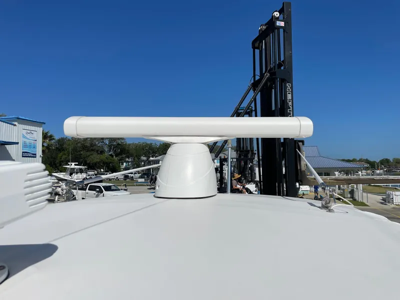 Slide: The Image of 2008 Intrepid 323 Cuddy boat radar system on deck under clear blue sky. - 43