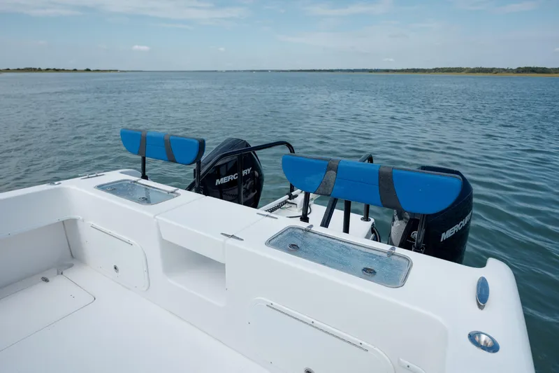 Slide: The Image of 2020 Prowler 31 boat with dual Mercury engines on a calm lake. - 11