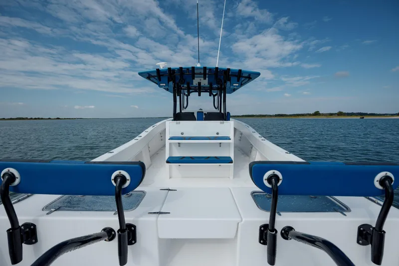 Slide: The Image of 2020 Prowler 31 boat on calm water under a blue sky. - 12