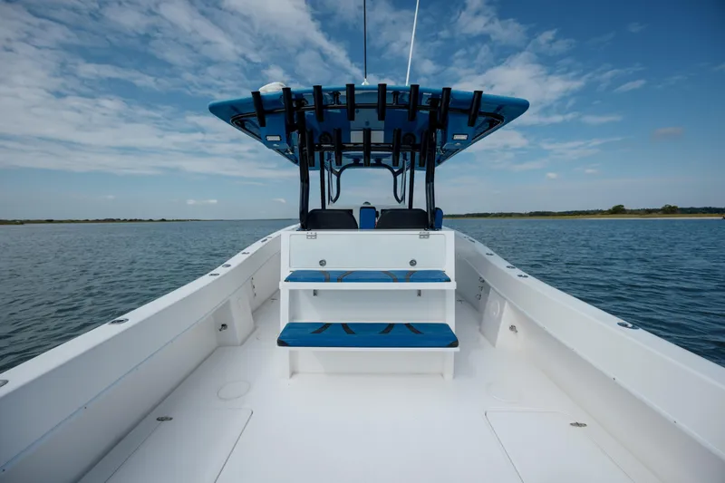 Slide: The Image of 2020 Prowler 31 boat on calm water under blue sky. - 13