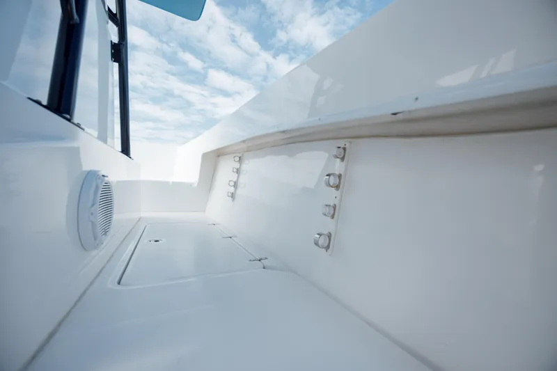 Slide: The Image of 2020 Prowler 31 boat interior with white deck and clear sky view. - 20