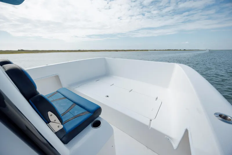 Slide: The Image of 2020 Prowler 31 boat interior with blue seating, overlooking calm waters and clear sky. - 21
