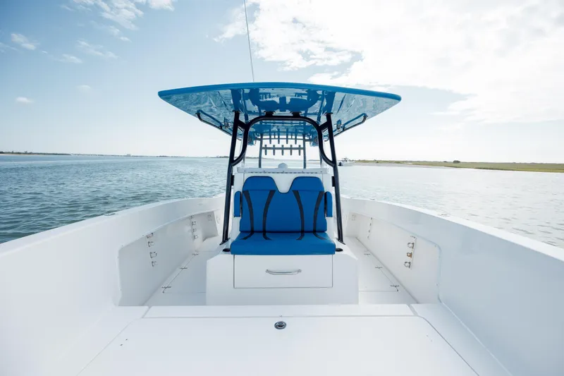 Slide: The Image of 2020 Prowler 31 boat with blue seating and canopy on open water. - 23