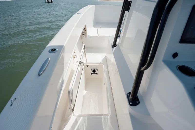 Slide: The Image of 2020 Prowler 31 boat deck with storage compartment, open on calm water. - 27