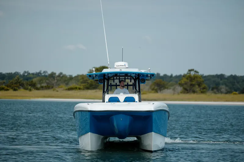 Slide: The Image of 2020 Prowler 31 boat cruising on calm water with scenic background. - 3