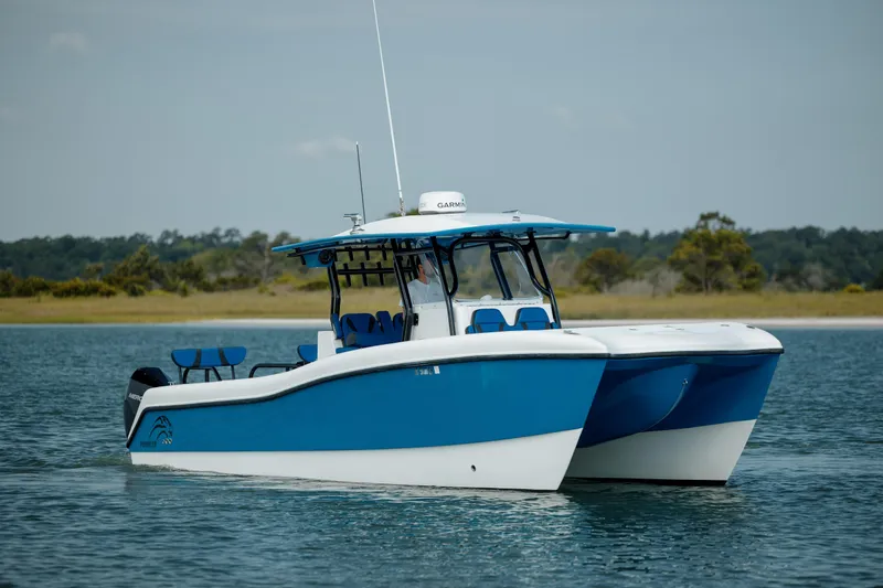 Slide: The Image of 2020 Prowler 31 boat on calm water, featuring a sleek blue and white design. - 4