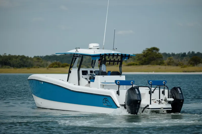 Slide: The Image of 2020 Prowler 31 boat with dual engines cruising on a calm lake. - 8