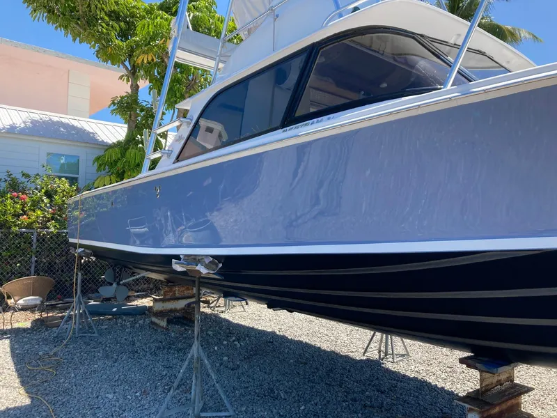 Slide: The Image of 1974 Bertram 31 Flybridge Cruiser on stands, side view, outdoors. - 14