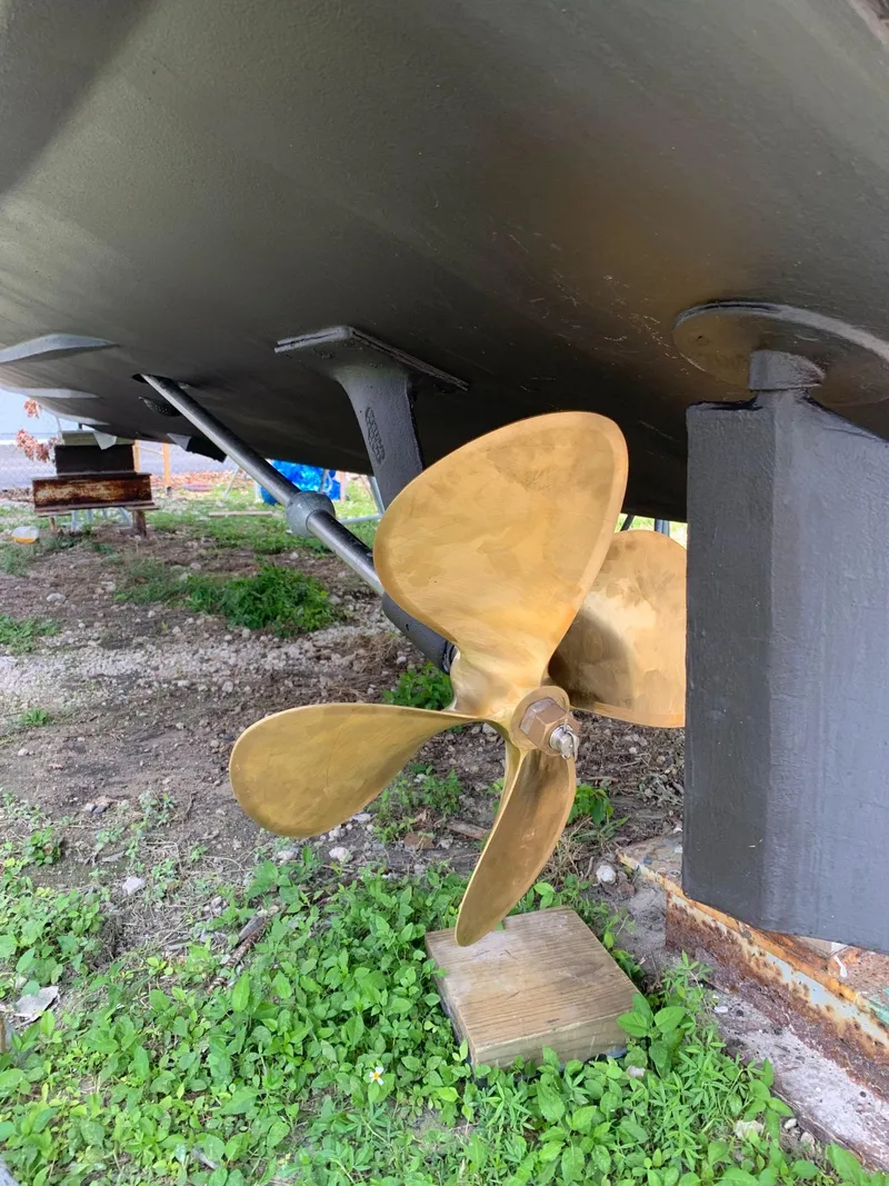 Slide: The Image of 1974 Bertram 31 Flybridge Cruiser propeller and hull on grassy ground. - 21