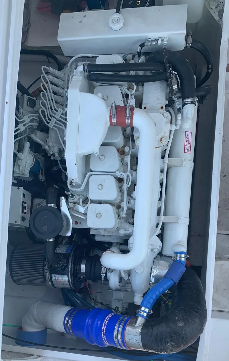 Slide: The Image of Engine compartment of a 1974 Bertram 31 Flybridge Cruiser, showcasing detailed mechanical components. - 22