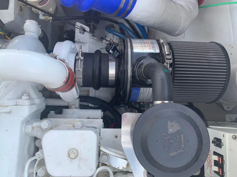 Slide: The Image of 1974 Bertram 31 Flybridge Cruiser engine compartment with visible air filter and components. - 24