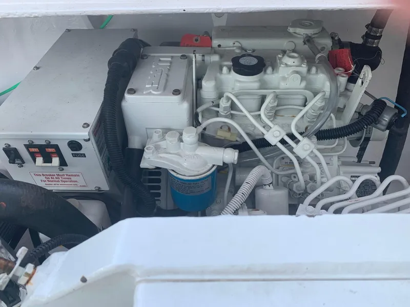 Slide: The Image of Engine compartment of a 1974 Bertram 31 Flybridge Cruiser, showcasing mechanical components. - 25