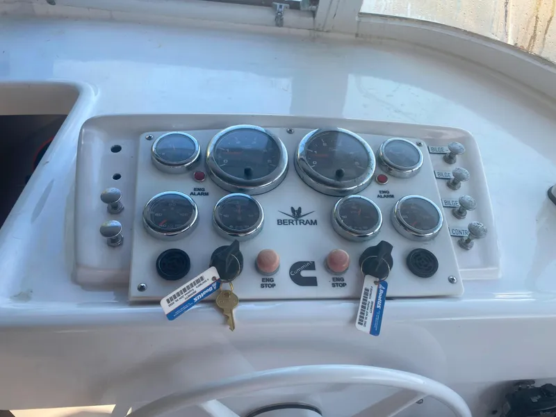 Slide: The Image of 1974 Bertram 31 Flybridge Cruiser dashboard with gauges and controls. - 7