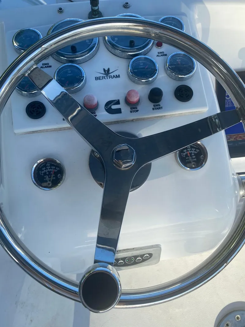 Slide: The Image of 1974 Bertram 31 Flybridge Cruiser steering wheel and dashboard controls. - 8