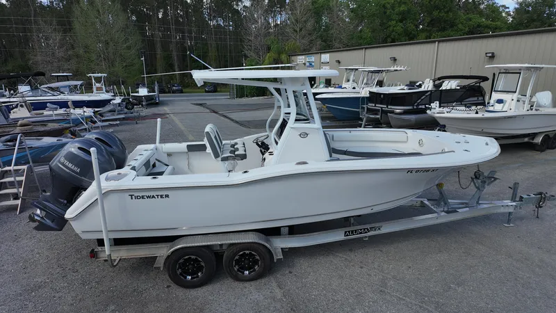 Slide: The Image of 2020 Tidewater 252 CC Adventure boat on trailer in marina setting. - 14