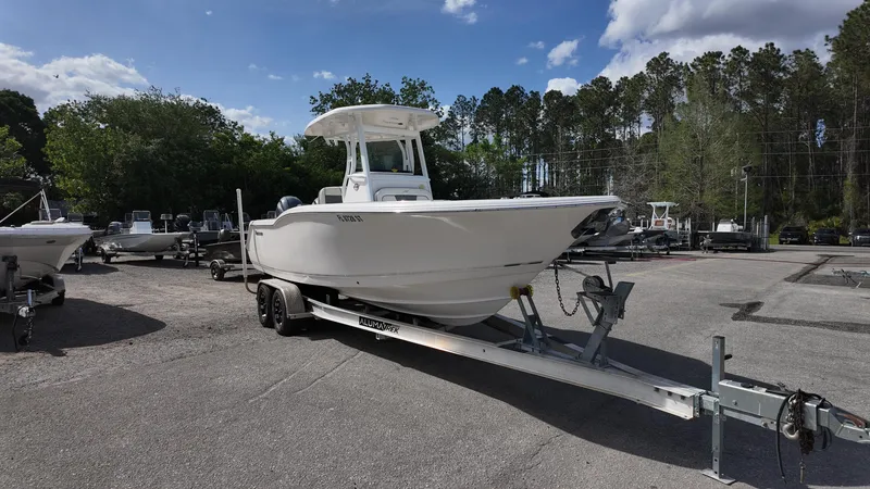 Slide: The Image of 2020 Tidewater 252 CC Adventure boat on trailer in outdoor lot. - 2