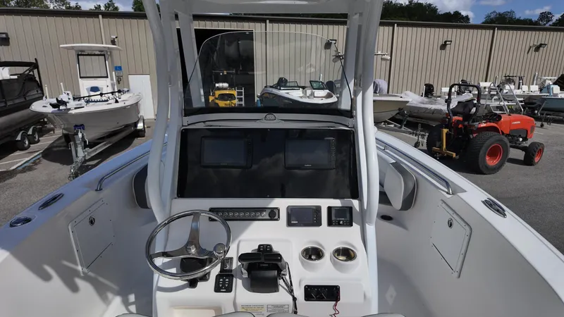 Slide: The Image of 2020 Tidewater 252 CC Adventure boat dashboard with steering wheel and controls. - 33