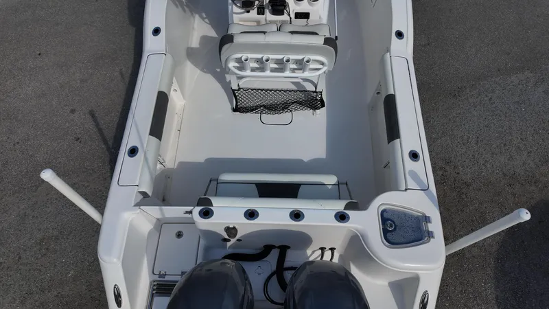 Slide: The Image of 2020 Tidewater 252 CC Adventure boat interior, featuring dual engines and spacious seating. - 34