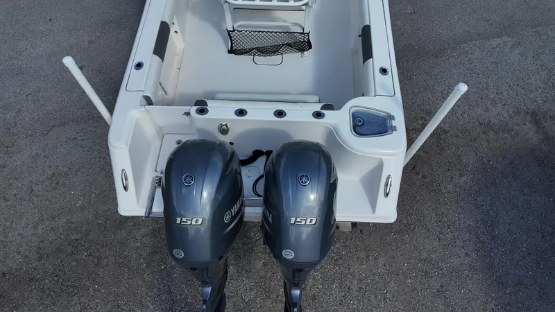 Slide: The Image of 2020 Tidewater 252 CC Adventure boat with dual 150 horsepower engines, rear view. - 35