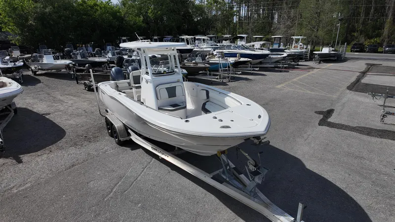Slide: The Image of 2020 Tidewater 252 CC Adventure boat on trailer in a marina parking lot. - 4