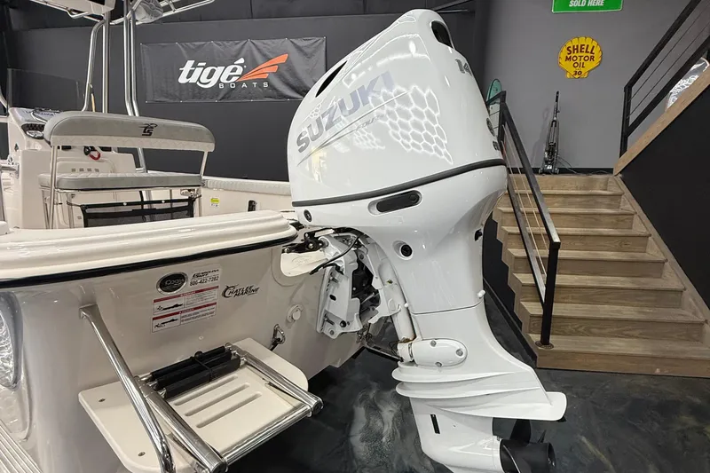 Slide: The Image of 2024 Carolina Skiff 21 LS boat with Suzuki outboard motor in showroom. - 13