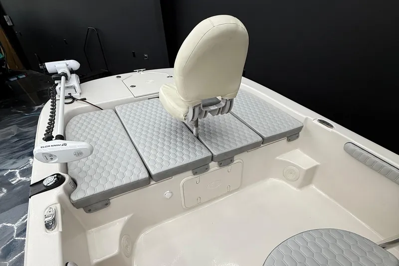 Slide: The Image of 2024 Carolina Skiff 21 LS boat interior with cushioned seating and trolling motor. - 14
